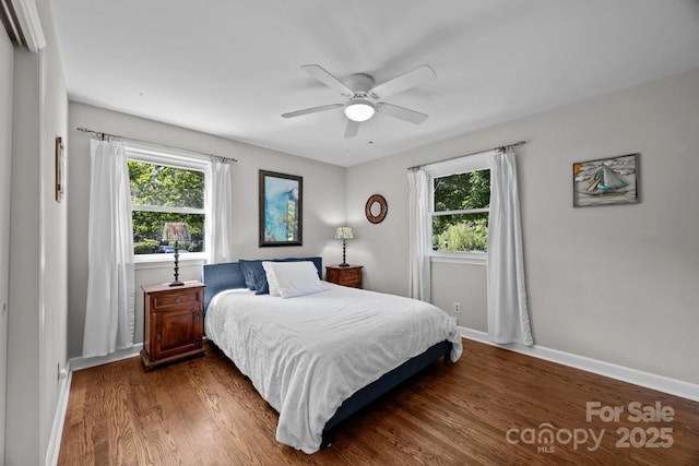 bedroom featuring a ceiling fan, wood finished floors, and baseboards