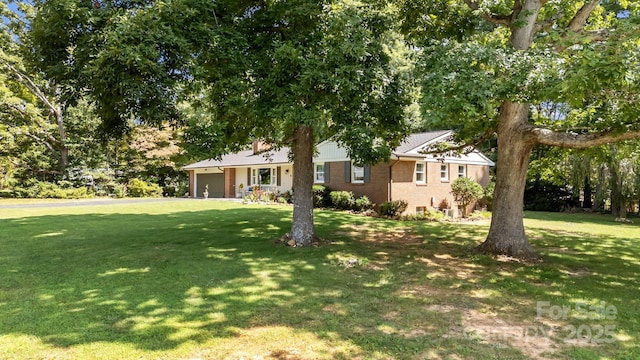 view of front of property with a garage and a front yard