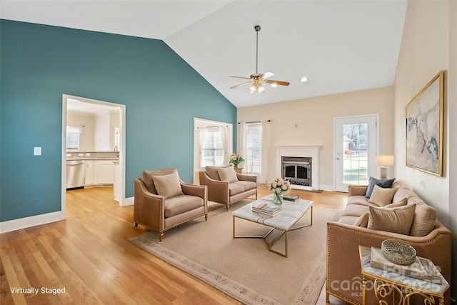 living room featuring ceiling fan, high vaulted ceiling, and light wood-type flooring