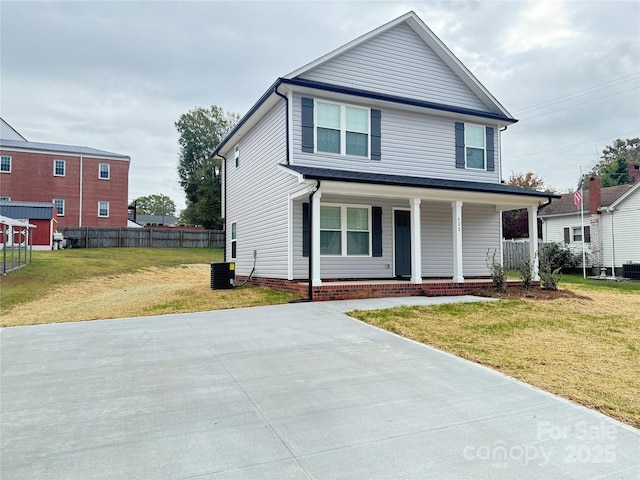 view of front of home featuring cooling unit, a front yard, and a porch