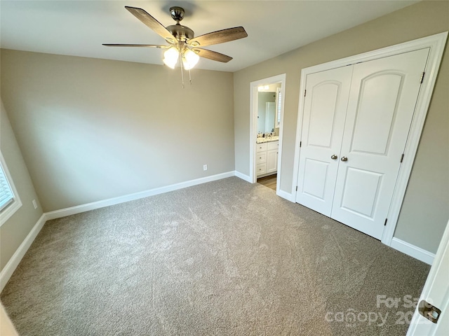 unfurnished bedroom with carpet flooring, connected bathroom, ceiling fan, and a closet