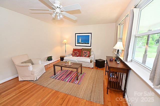 living room featuring hardwood / wood-style floors and ceiling fan