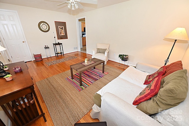 living room featuring hardwood / wood-style flooring and ceiling fan