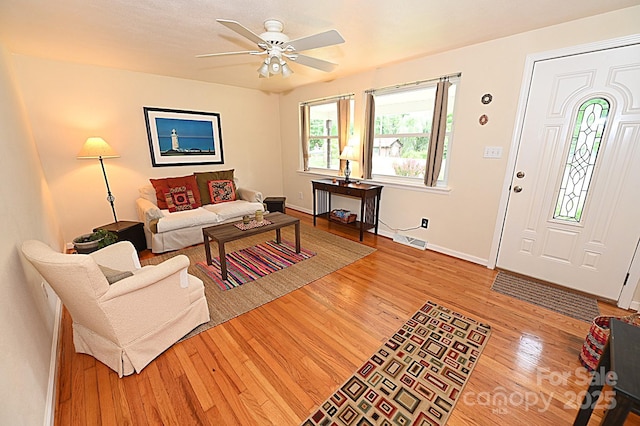 living room featuring light hardwood / wood-style flooring and ceiling fan