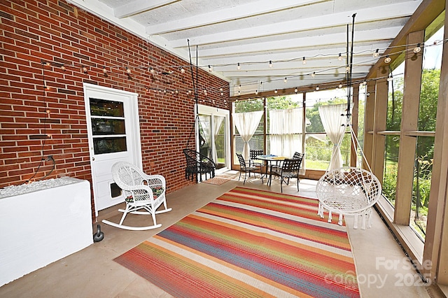 sunroom featuring beamed ceiling