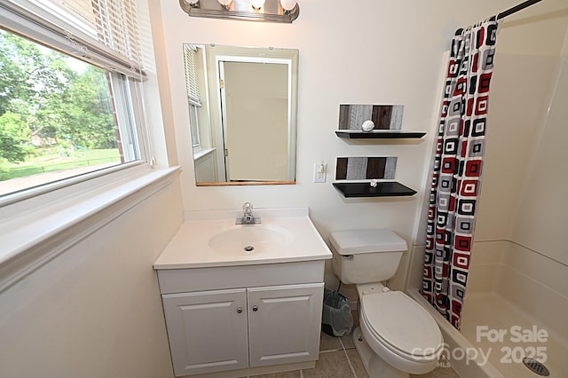 bathroom with vanity, tile patterned flooring, curtained shower, and toilet