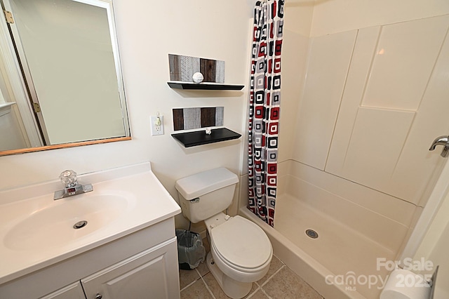 bathroom featuring vanity, tile patterned flooring, curtained shower, and toilet