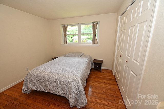 bedroom with wood-type flooring and a closet