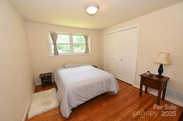 bedroom featuring wood-type flooring and a closet