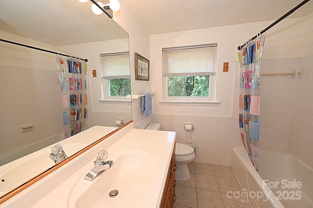 full bathroom with shower / bath combo, tile walls, tile patterned flooring, vanity, and toilet