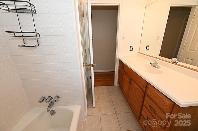 bathroom featuring vanity, tile patterned flooring, and a washtub