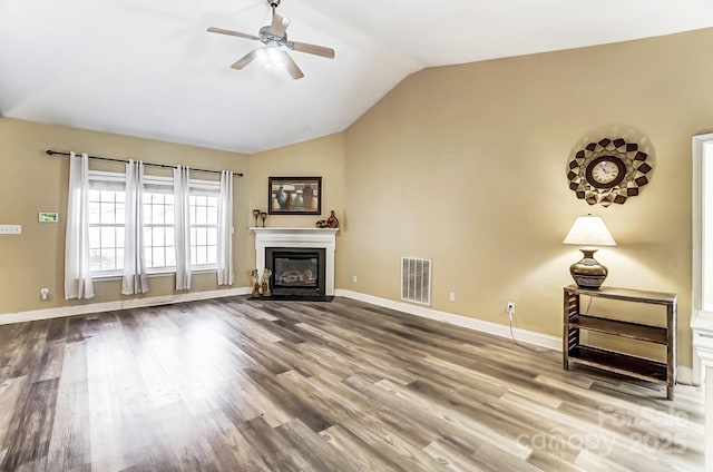 unfurnished living room featuring wood-type flooring, lofted ceiling, and ceiling fan