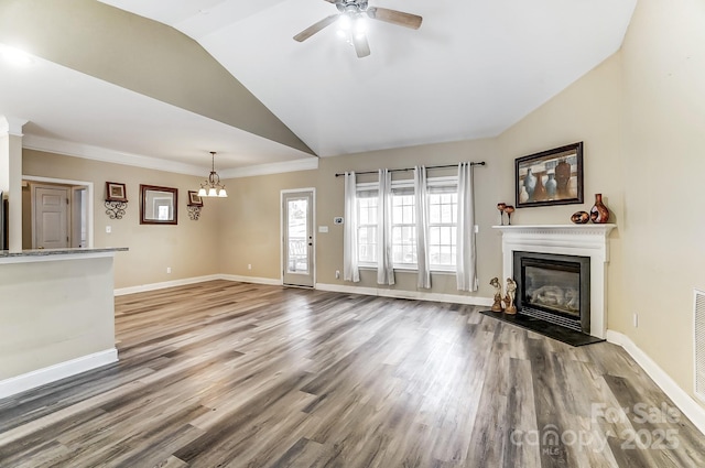 unfurnished living room featuring ceiling fan with notable chandelier, lofted ceiling, and hardwood / wood-style floors