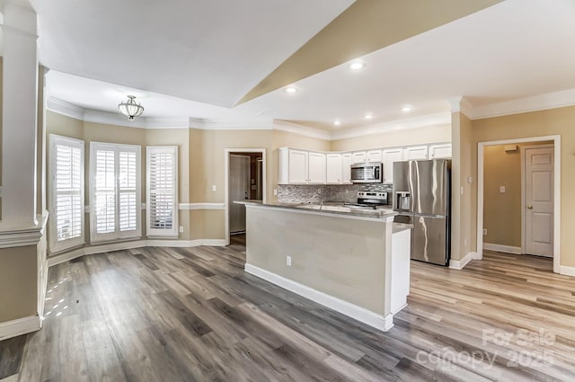 kitchen featuring white cabinetry, appliances with stainless steel finishes, and ornamental molding