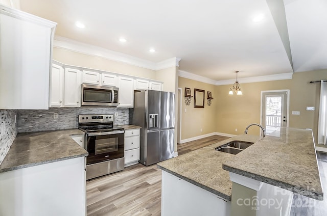 kitchen with hanging light fixtures, sink, a center island, and appliances with stainless steel finishes