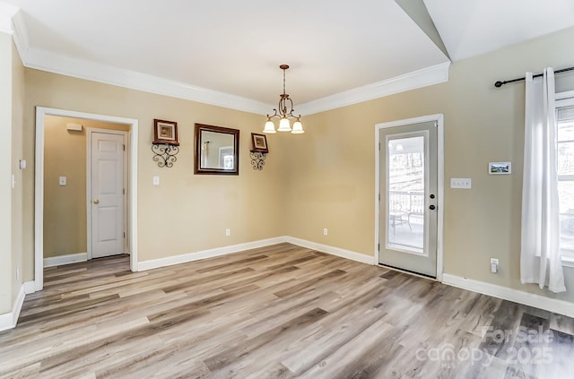 unfurnished dining area featuring an inviting chandelier, ornamental molding, and light wood-type flooring