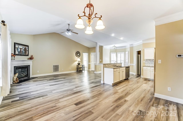 kitchen with pendant lighting, dishwasher, sink, a kitchen island with sink, and light hardwood / wood-style flooring