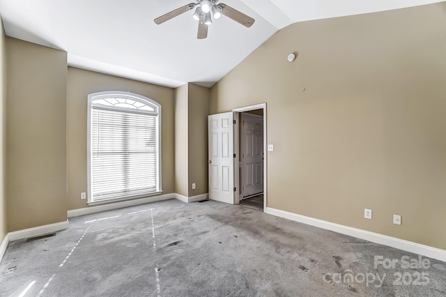 carpeted empty room with vaulted ceiling and ceiling fan