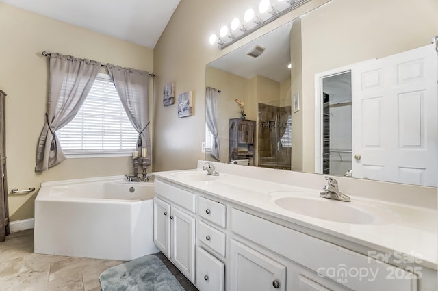 bathroom featuring lofted ceiling, vanity, and independent shower and bath