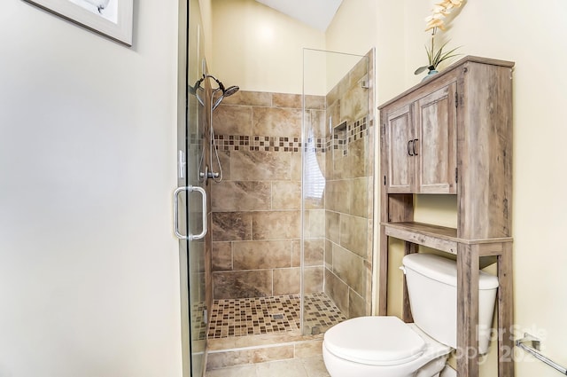 bathroom featuring walk in shower and toilet