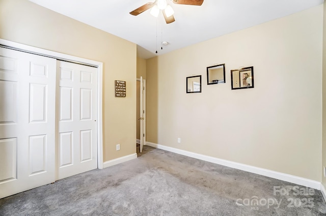 unfurnished bedroom featuring ceiling fan, light colored carpet, and a closet