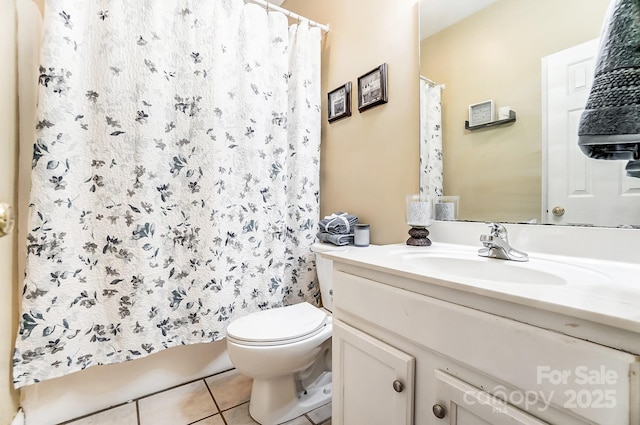 bathroom featuring vanity, tile patterned floors, and toilet