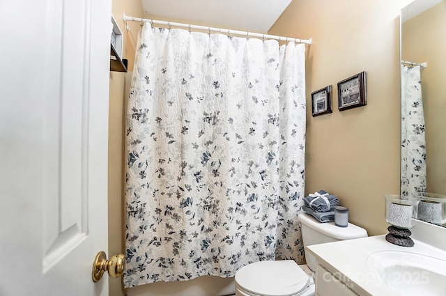 bathroom with vanity, toilet, and walk in shower