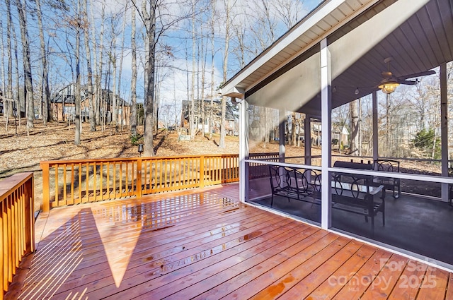 wooden deck featuring ceiling fan