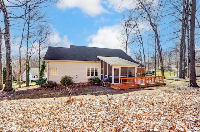 rear view of property with a wooden deck and a sunroom