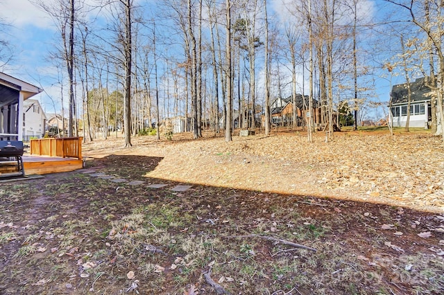 view of yard with a deck and a sunroom