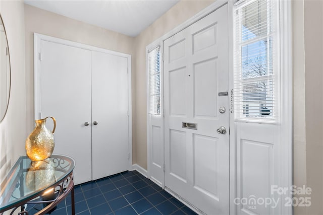 foyer with dark tile patterned flooring