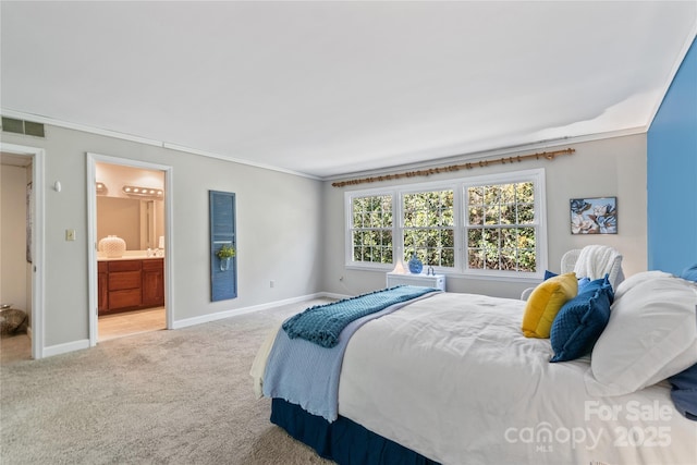 carpeted bedroom with ornamental molding, visible vents, baseboards, and ensuite bathroom