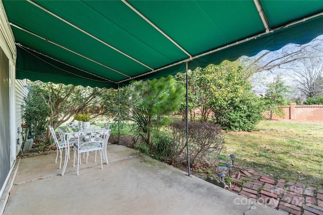 view of patio / terrace with outdoor dining space and fence