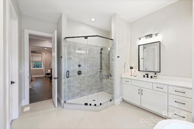 bathroom with tile patterned flooring, vanity, and an enclosed shower