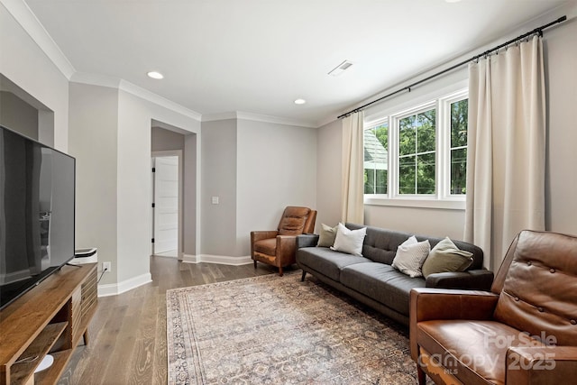 living room featuring ornamental molding and hardwood / wood-style floors