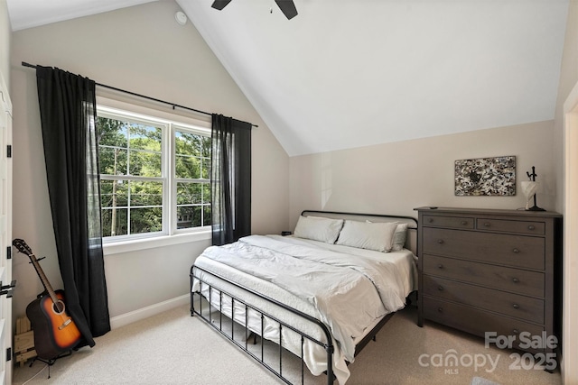 carpeted bedroom featuring lofted ceiling and ceiling fan