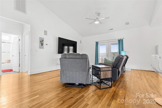 living room featuring hardwood / wood-style flooring, high vaulted ceiling, ceiling fan, and french doors