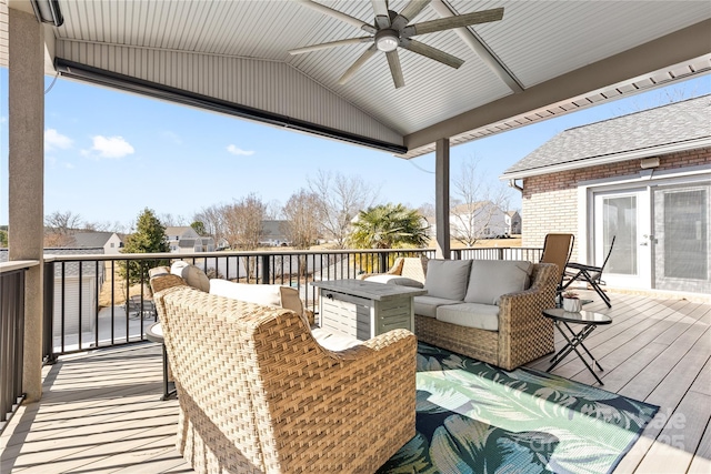 wooden terrace with an outdoor living space and ceiling fan