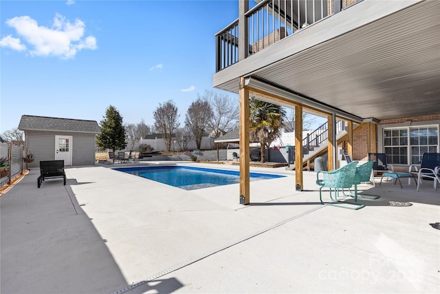 view of pool featuring a patio and a storage unit