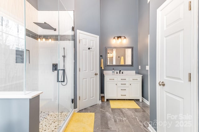 bathroom with vanity and a shower with door