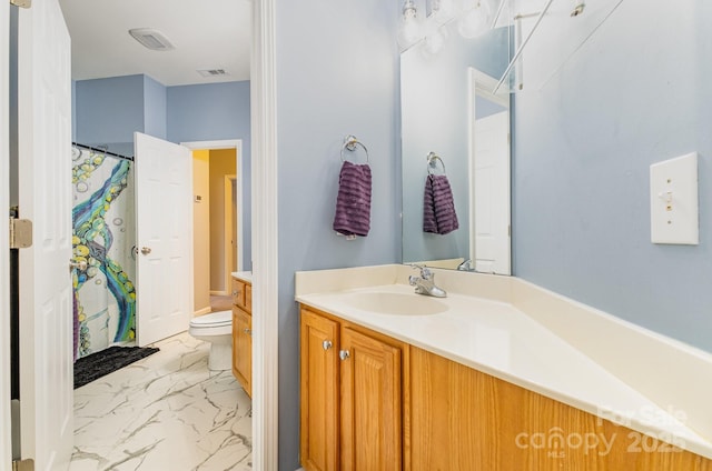 bathroom featuring vanity, walk in shower, and toilet