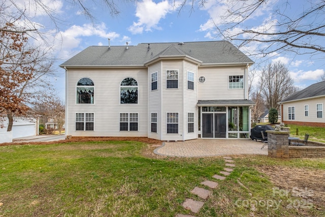 rear view of property featuring a yard and a patio