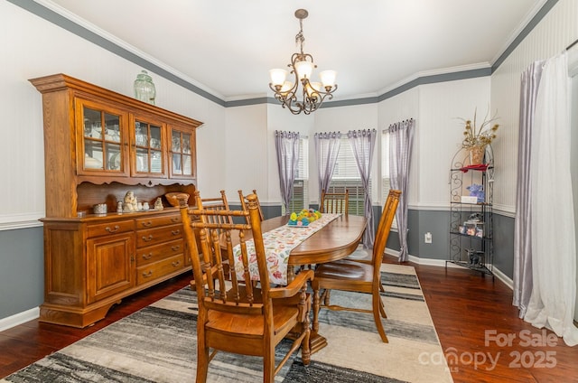 dining room featuring a notable chandelier, crown molding, and dark wood-type flooring