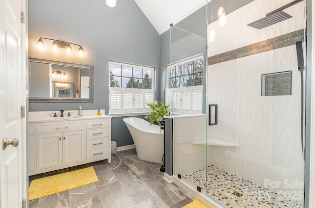 bathroom featuring lofted ceiling, separate shower and tub, and vanity