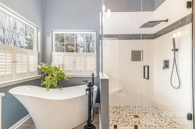 bathroom featuring shower with separate bathtub