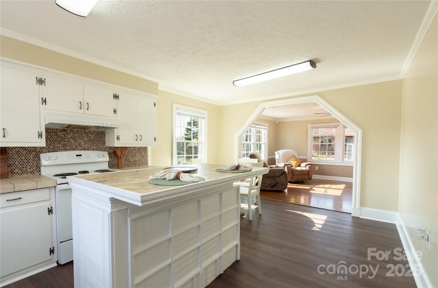 kitchen featuring tile countertops, white cabinets, backsplash, ornamental molding, and white range with electric cooktop