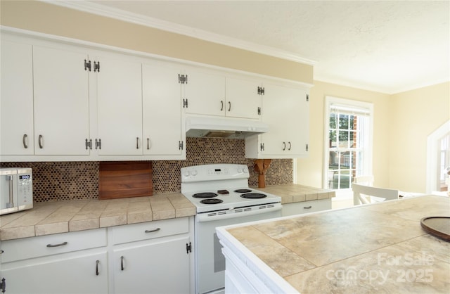 kitchen with white cabinetry, white appliances, and tile counters