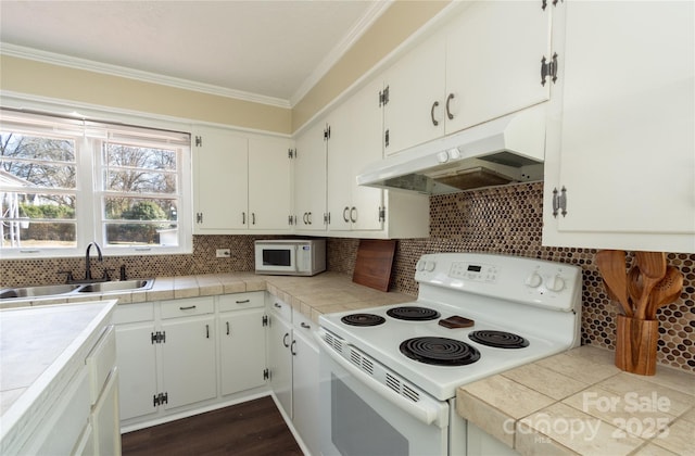 kitchen featuring sink, white appliances, ornamental molding, white cabinets, and tile countertops