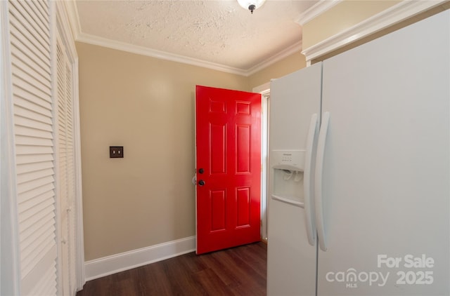 entrance foyer featuring ornamental molding, dark wood-type flooring, and a textured ceiling