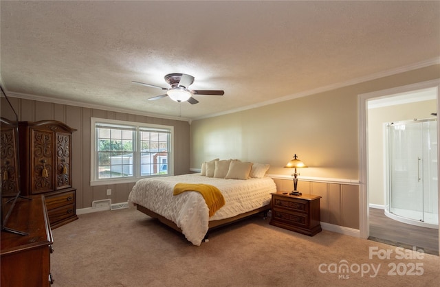 bedroom with crown molding, carpet, and a textured ceiling